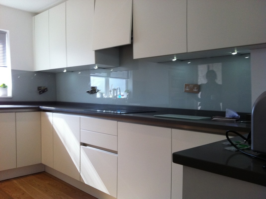 Grey glass kitchen splashback with LED lighting in Holland Park