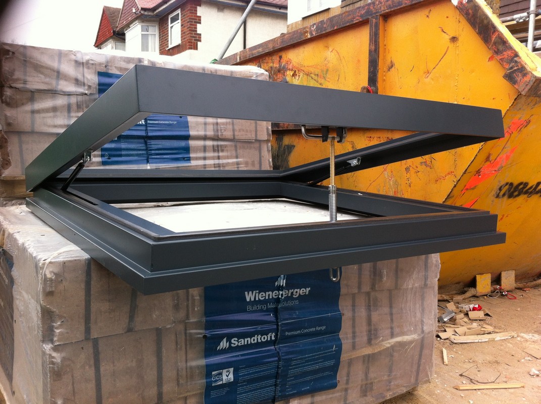 Opening flat roof skylight in anthracite grey installed in Holland Park